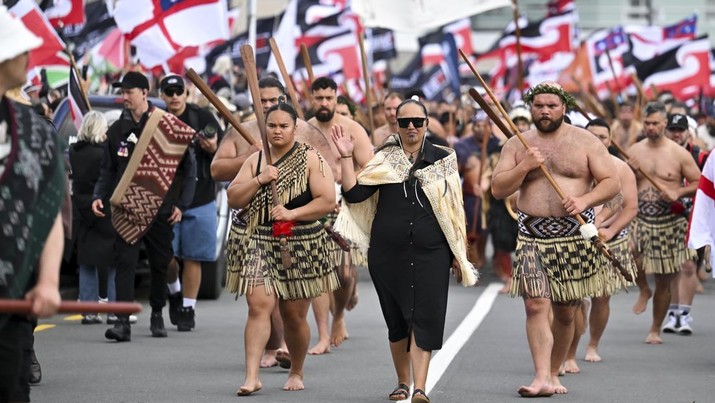 Anggota masyarakat Maori berpawai dalam aksi unjuk rasa untuk mengkritik pemerintah atas kebijakannya yang berdampak pada penduduk asli Maori di Wellington pada (19/11/2024). (AP Photo/Mark Tantrum)
