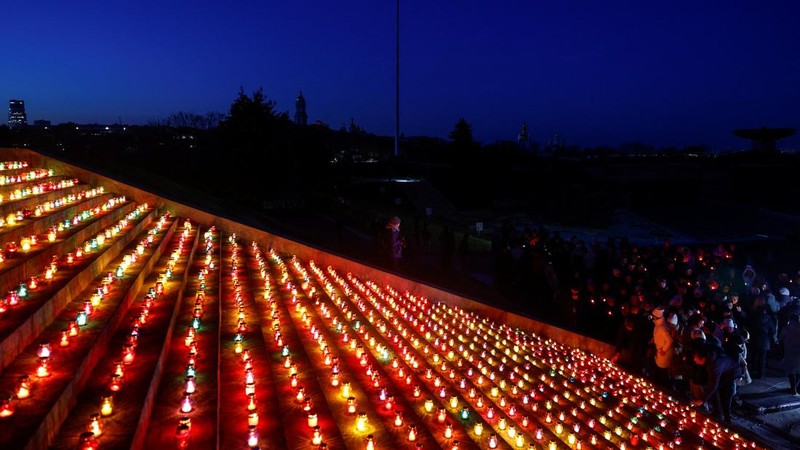 Warga Kota Kyiv, Ukraina, menggelar acara khusus untuk memperingati 1.000 hari sejak invasi besar-besaran Rusia dimulai pada 24 Februari 2022. Dalam peringatan ini, mereka menyalakan seribu lilin dan berdoa di depan Monumen Ibu Pertiwi. (REUTERS/Valentyn Ogirenko)