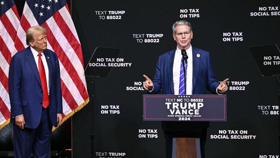 Republican presidential nominee former President Donald Trump, left, listens as investor Scott Bessent speaks on the economy in Asheville, N.C., Wednesday, Aug. 14, 2024. (AP Photo/Matt Kelley)