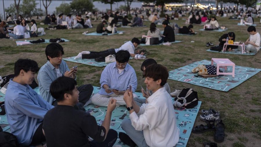 People spend time in Yeouido Hangang Park, a popular destination for both residents and tourists, in Seoul, Wednesday, May 22, 2024. (AP Photo/Jae C. Hong)