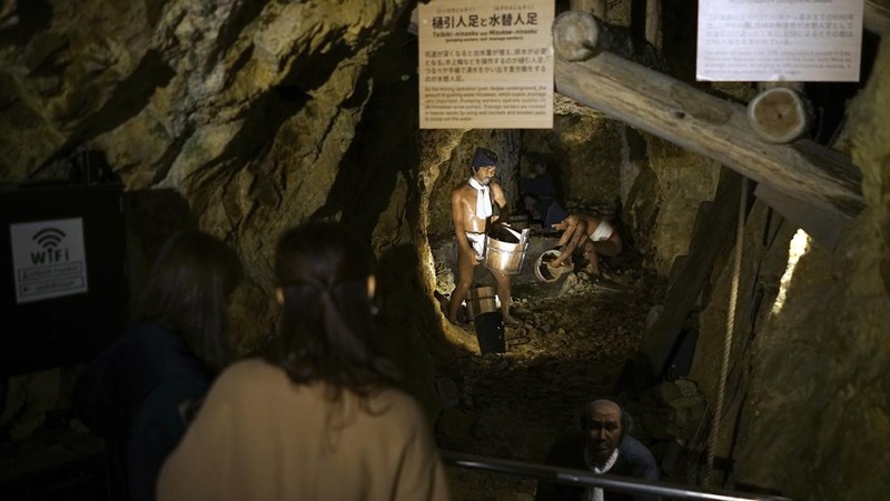 Guests offer a moment of silence during a memorial ceremony for the Sado Island Gold Mine in Sado, Niigata prefecture, Japan, Sunday, Nov. 24, 2024. (AP Photo/Eugene Hoshiko)