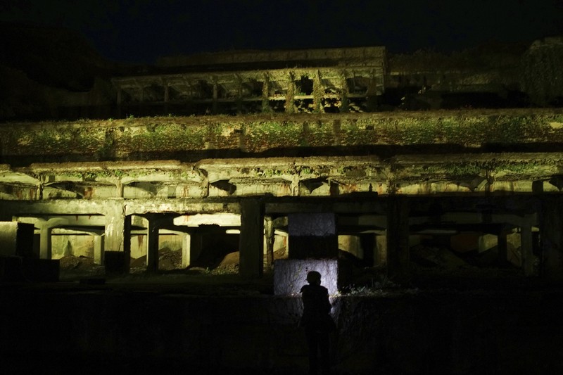 Guests offer a moment of silence during a memorial ceremony for the Sado Island Gold Mine in Sado, Niigata prefecture, Japan, Sunday, Nov. 24, 2024. (AP Photo/Eugene Hoshiko)