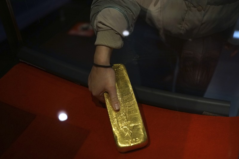 Guests offer a moment of silence during a memorial ceremony for the Sado Island Gold Mine in Sado, Niigata prefecture, Japan, Sunday, Nov. 24, 2024. (AP Photo/Eugene Hoshiko)