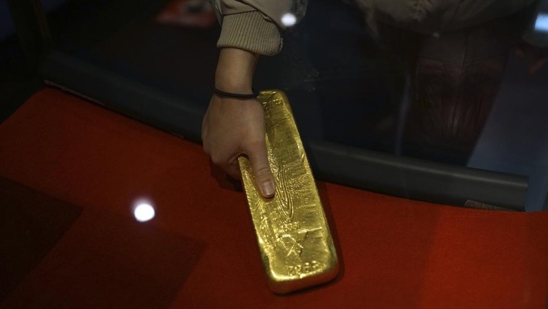 Guests offer a moment of silence during a memorial ceremony for the Sado Island Gold Mine in Sado, Niigata prefecture, Japan, Sunday, Nov. 24, 2024. (AP Photo/Eugene Hoshiko)