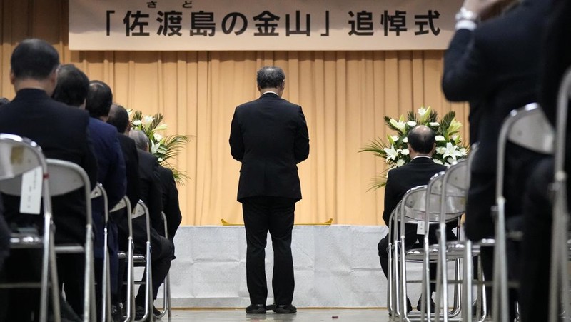 Guests offer a moment of silence during a memorial ceremony for the Sado Island Gold Mine in Sado, Niigata prefecture, Japan, Sunday, Nov. 24, 2024. (AP Photo/Eugene Hoshiko)