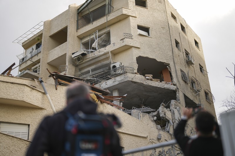 ISRAEL-PALESTINIANS/LEBANON People check their family's damaged house at the scene where one of the projectiles fell, after projectiles crossed over to Israel from Lebanon, amid ongoing hostilities between Hezbollah and Israel, in Rinatiya, Israel, November 24, 2024. REUTERS/Itai Ron ISRAEL OUT. NO COMMERCIAL OR EDITORIAL SALES IN ISRAEL REFILE - CORRECTING