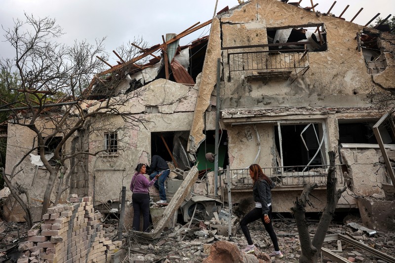 People check their family's damaged house at the scene where one of the projectiles fell, after projectiles crossed over to Israel from Lebanon, amid ongoing hostilities between Hezbollah and Israel, in Rinatiya, Israel, November 24, 2024. REUTERS/Itai Ron  ISRAEL OUT. NO COMMERCIAL OR EDITORIAL SALES IN ISRAEL   REFILE - CORRECTING 