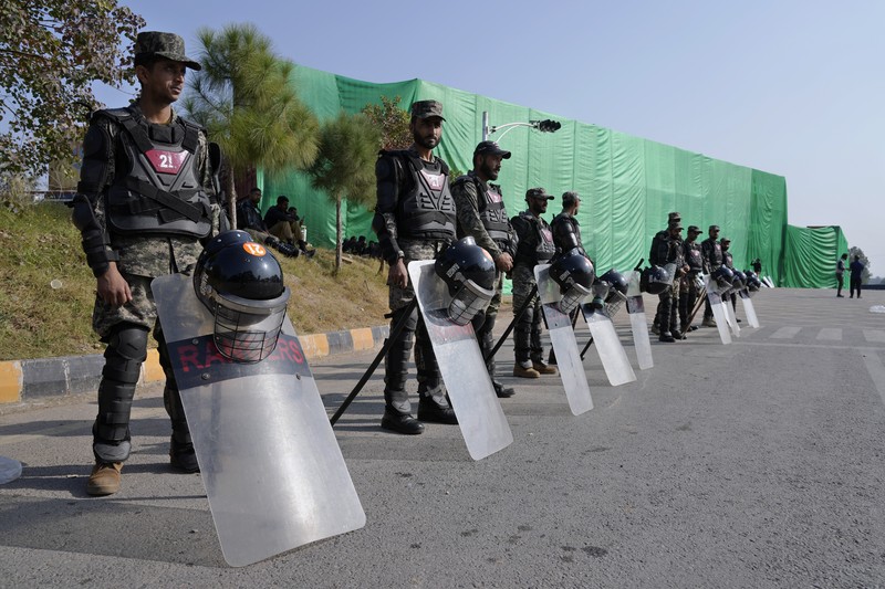Paramilitary soldiers patrol as they station at a overhead bridge ahead of a planned rally by supporters of imprisoned former Prime Minister Imran Khan's Pakistan Tehreek-e-Insaf party, in Islamabad, Pakistan, Sunday, Nov. 24, 2024. (AP Photo/Anjum Naveed)