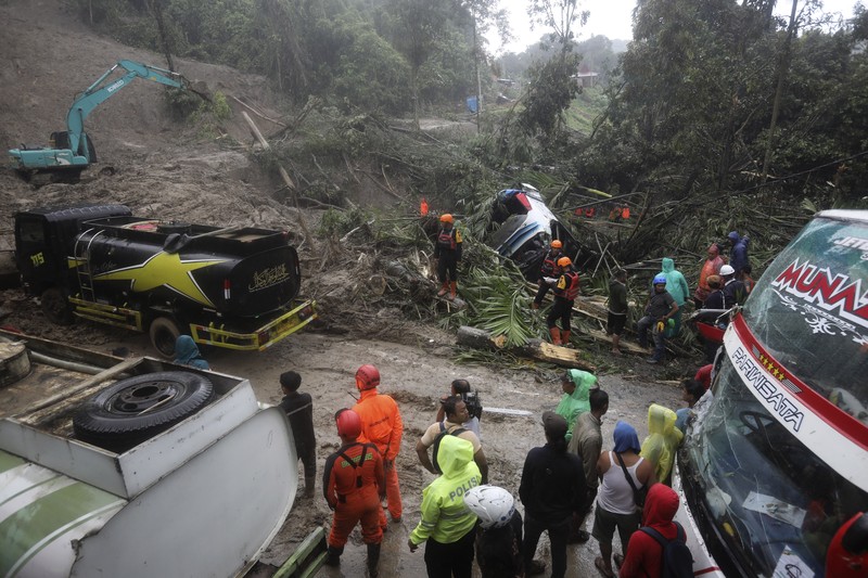 Rescuers remove the body of a victim from the wreckage of a vehicle after it was hit by a landslide that killed multiple people in Deli Serdang, North Sumatra, Indonesia, Thursday, Nov. 28, 2024. (AP Photo/Binsar Bakkara)