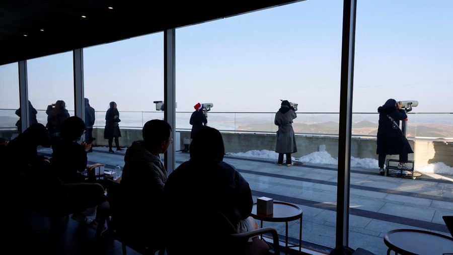 Pelanggan mengantre di depan toko baru Starbucks di puncak Observatorium Puncak Aegibong, selatan zona demiliterisasi (DMZ), yang memisahkan kedua Korea, di Gimpo, Korea Selatan, 29 November 2024. (REUTERS/Kim Soo-hyeon)