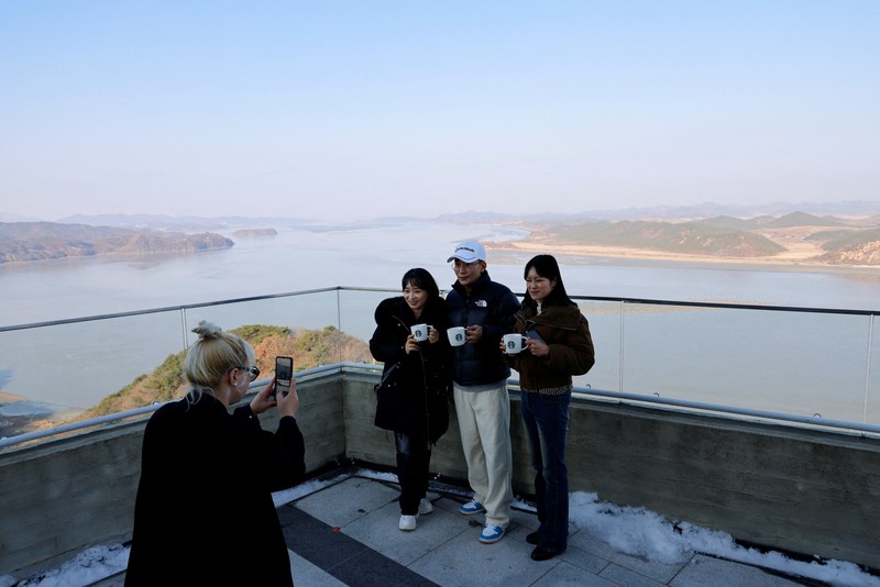 Pelanggan mengantre di depan toko baru Starbucks di puncak Observatorium Puncak Aegibong, selatan zona demiliterisasi (DMZ), yang memisahkan kedua Korea, di Gimpo, Korea Selatan, 29 November 2024. (REUTERS/Kim Soo-hyeon)
