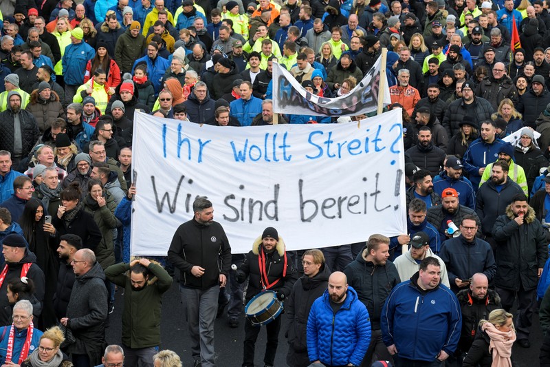 Para pekerja pabrikan mobil asal Jerman, Volkswagen melakukan membawa bendera saat mereka melakukan mogok kerja di Hanover, Jerman, Senin (2/12/2024). (REUTERS/Fabian Bimmer) Para pekerja pabrikan mobil asal Jerman, Volkswagen melakukan membawa bendera saat mereka melakukan mogok kerja di Hanover, Jerman, Senin (2/12/2024). (REUTERS/Fabian Bimmer)