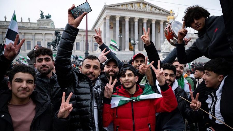 Orang-orang memegang bendera oposisi Suriah saat merayakan, setelah komando tentara Suriah memberi tahu para perwira pada hari Minggu bahwa pemerintahan otoriter Presiden Bashar al-Assad selama 24 tahun telah berakhir, seorang perwira Suriah yang diberitahu tentang tindakan tersebut mengatakan kepada Reuters, menyusul serangan pemberontak cepat yang mengejutkan dunia, di Aleppo, Suriah 8 Desember 2024. (REUTERS/Karam al-Masri)