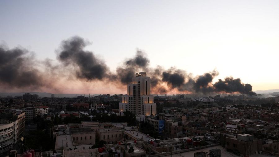 Smoke rises, after Syrian rebels announced that they have ousted Syria's Bashar al-Assad, in Damascus,  Syria, December 8, 2024. REUTERS/Mohamed Azakir     TPX IMAGES OF THE DAY