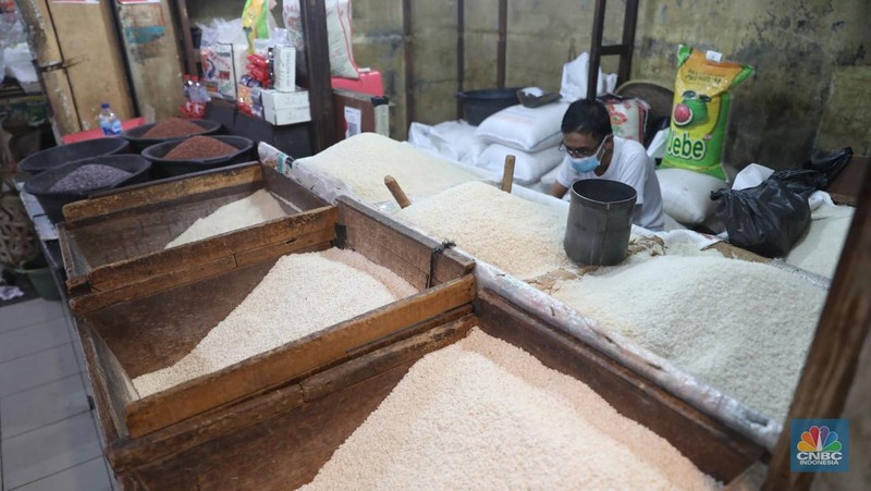 Pekerja menata beras di Kawasan Pasar Kebayoran Lama, Jakarta, Jumat, (13/12/2024). (CNBC Indonesia/Muhammad Sabki)