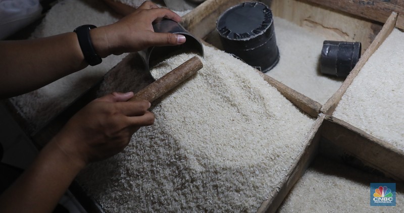 Pekerja menata beras di Kawasan Pasar Kebayoran Lama, Jakarta, Jumat, (13/12/2024). (CNBC Indonesia/Muhammad Sabki)