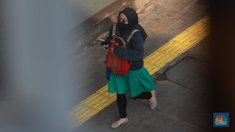 Sejumlah pekerja berjalan pulang di Kawasan Sudirman, Jakarta, Jumat (13/12/2024). (CNBC Indonesia/Muhammad Sabki)