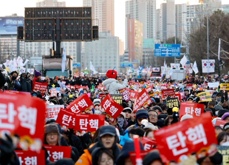 Para pengunjuk rasa berpartisipasi dalam unjuk rasa yang menyerukan pemakzulan Presiden Korea Selatan Yoon Suk Yeol, yang mengumumkan darurat militer, yang dicabut beberapa jam kemudian, di depan Majelis Nasional di Seoul, Korea Selatan, 14 Desember 2024. Para pengunjuk rasa berpartisipasi dalam unjuk rasa yang menyerukan pemakzulan Presiden Korea Selatan Yoon Suk Yeol, yang mengumumkan darurat militer, yang dicabut beberapa jam kemudian, di depan Majelis Nasional di Seoul, Korea Selatan, 14 Desember 2024. (Yonhap via REUTERS)