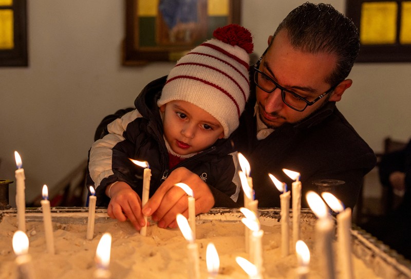 Members of the Orthodox community of Latakia attend a Sunday Mass conducted by Athanasios Fahed, Metropolitan of Latakia and its dependencies for the Greek Orthodox, at St. George's Cathedral in Latakia, Syria, December 15, 2024. REUTERS/Umit Bektas     TPX IMAGES OF THE DAY