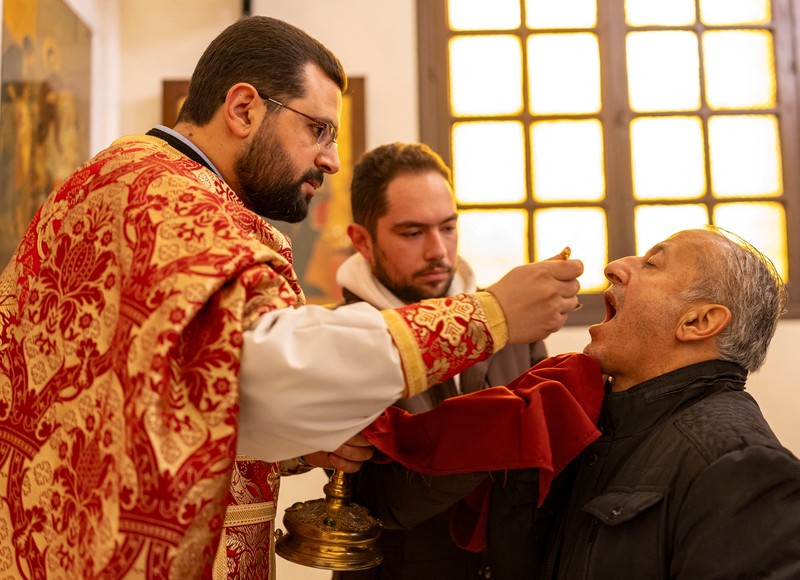 Members of the Orthodox community of Latakia attend a Sunday Mass conducted by Athanasios Fahed, Metropolitan of Latakia and its dependencies for the Greek Orthodox, at St. George's Cathedral in Latakia, Syria, December 15, 2024. REUTERS/Umit Bektas     TPX IMAGES OF THE DAY