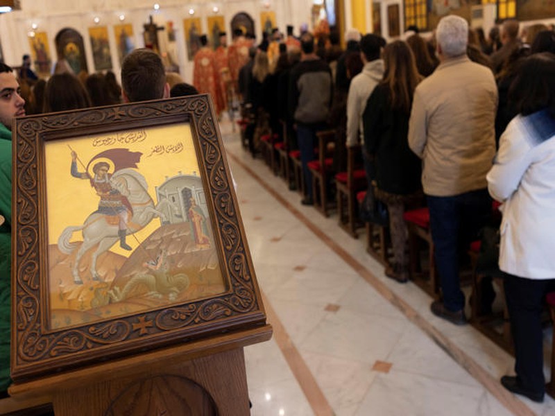 Members of the Orthodox community of Latakia attend a Sunday Mass conducted by Athanasios Fahed, Metropolitan of Latakia and its dependencies for the Greek Orthodox, at St. George's Cathedral in Latakia, Syria, December 15, 2024. REUTERS/Umit Bektas     TPX IMAGES OF THE DAY