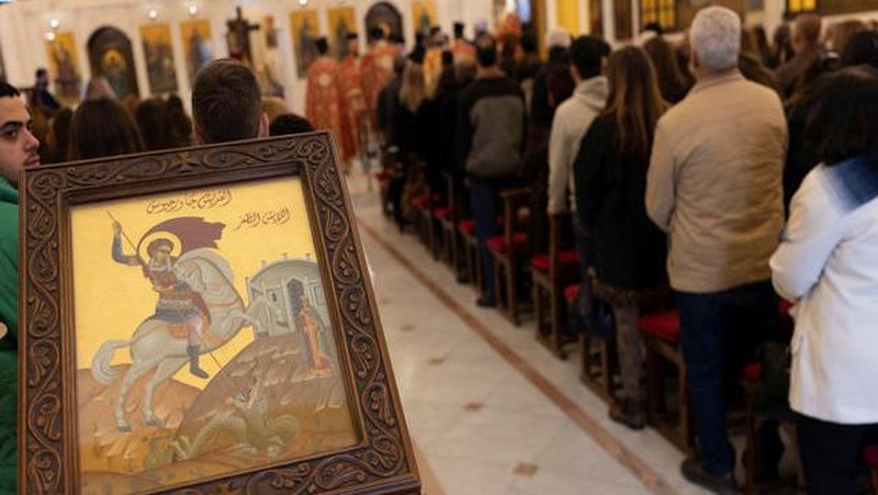 Members of the Orthodox community of Latakia attend a Sunday Mass conducted by Athanasios Fahed, Metropolitan of Latakia and its dependencies for the Greek Orthodox, at St. George's Cathedral in Latakia, Syria, December 15, 2024. REUTERS/Umit Bektas     TPX IMAGES OF THE DAY