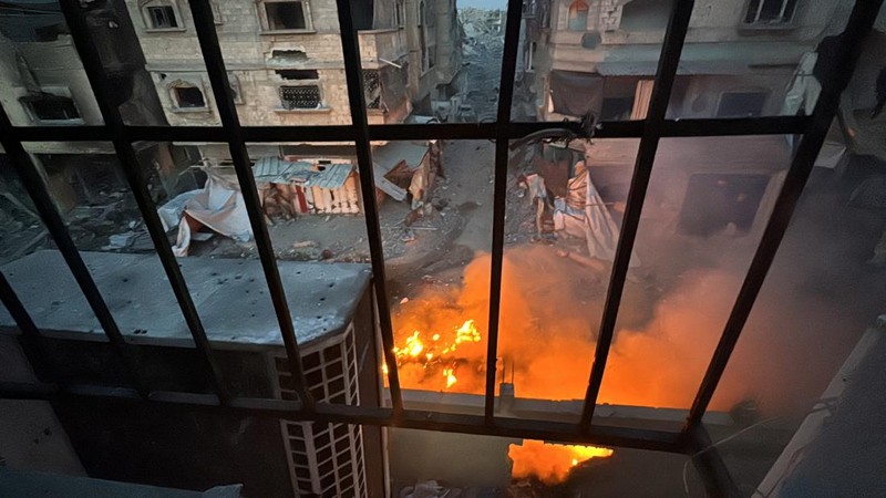 A fire burns inside a Palestinian house during the ongoing Israeli military operation, amid Israel-Hamas conflict, in Beit Lahiya, in the northern Gaza Strip, December 18, 2024. REUTERS/Stringer      TPX IMAGES OF THE DAY