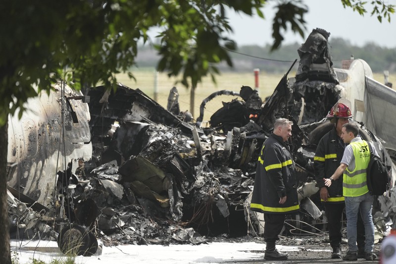 Puing-puing pesawat pribadi tergeletak di samping rumah-rumah setelah jatuh di dekat bandara di San Fernando di pinggiran Buenos Aires, Argentina, Rabu, 18 Desember 2024. (AP Photo/Natacha Pisarenko)
