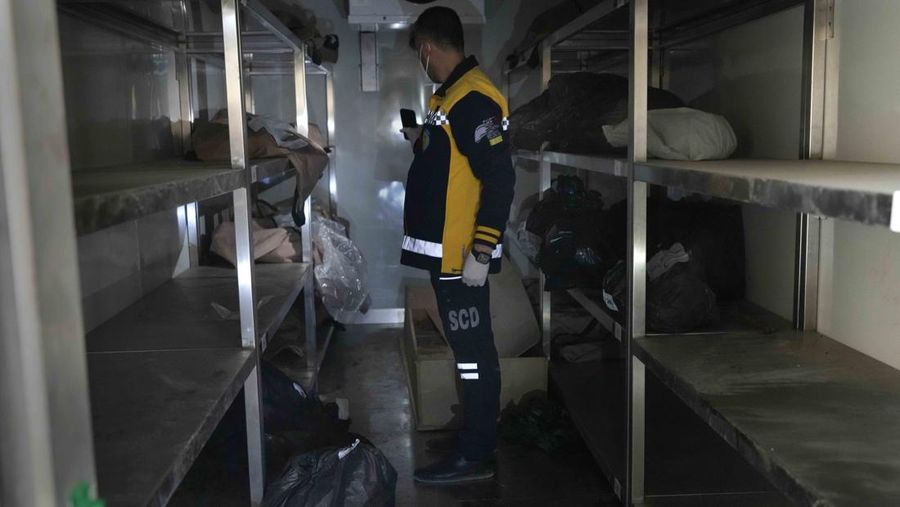 A Syrian civil defense team, known as the White Helmets, inspects a morgue, previously used by pro-government Iranian units, located near the Set Zainab shrine, south of Damascus, Syria, on Wednesday, Dec. 18, 2024 (AP Photo/Hussein Malla)