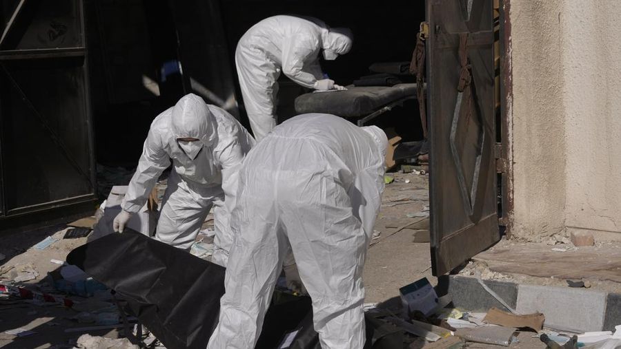 A Syrian civil defense team, known as the White Helmets, inspects a morgue, previously used by pro-government Iranian units, located near the Set Zainab shrine, south of Damascus, Syria, on Wednesday, Dec. 18, 2024 (AP Photo/Hussein Malla)