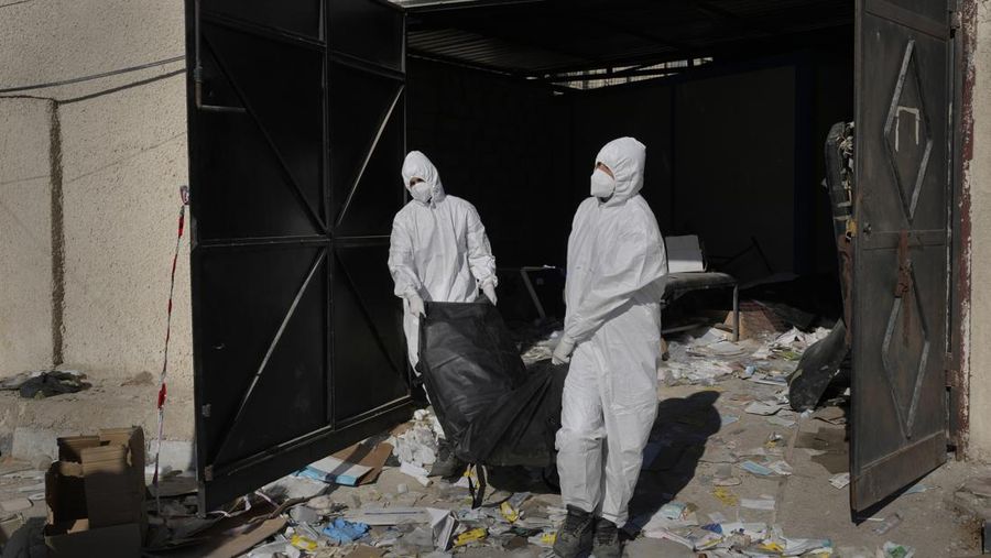 A Syrian civil defense team, known as the White Helmets, inspects a morgue, previously used by pro-government Iranian units, located near the Set Zainab shrine, south of Damascus, Syria, on Wednesday, Dec. 18, 2024 (AP Photo/Hussein Malla)