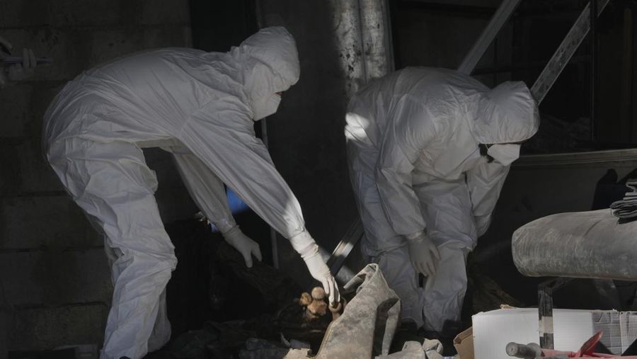 A Syrian civil defense team, known as the White Helmets, inspects a morgue, previously used by pro-government Iranian units, located near the Set Zainab shrine, south of Damascus, Syria, on Wednesday, Dec. 18, 2024 (AP Photo/Hussein Malla)