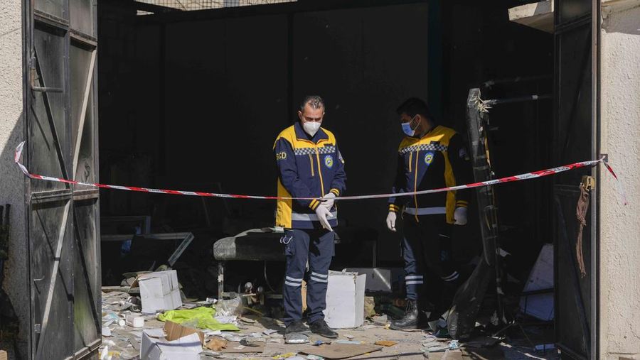 A Syrian civil defense team, known as the White Helmets, inspects a morgue, previously used by pro-government Iranian units, located near the Set Zainab shrine, south of Damascus, Syria, on Wednesday, Dec. 18, 2024 (AP Photo/Hussein Malla)