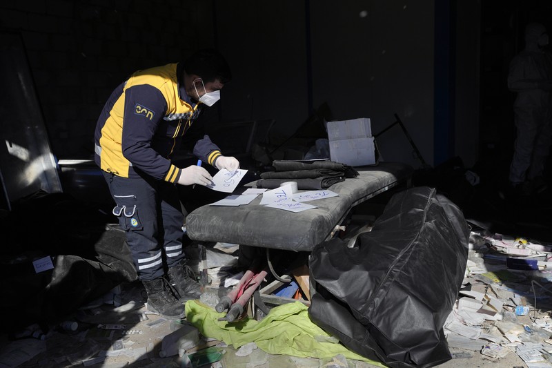 A Syrian civil defense team, known as the White Helmets, inspects a morgue, previously used by pro-government Iranian units, located near the Set Zainab shrine, south of Damascus, Syria, on Wednesday, Dec. 18, 2024 (AP Photo/Hussein Malla)
