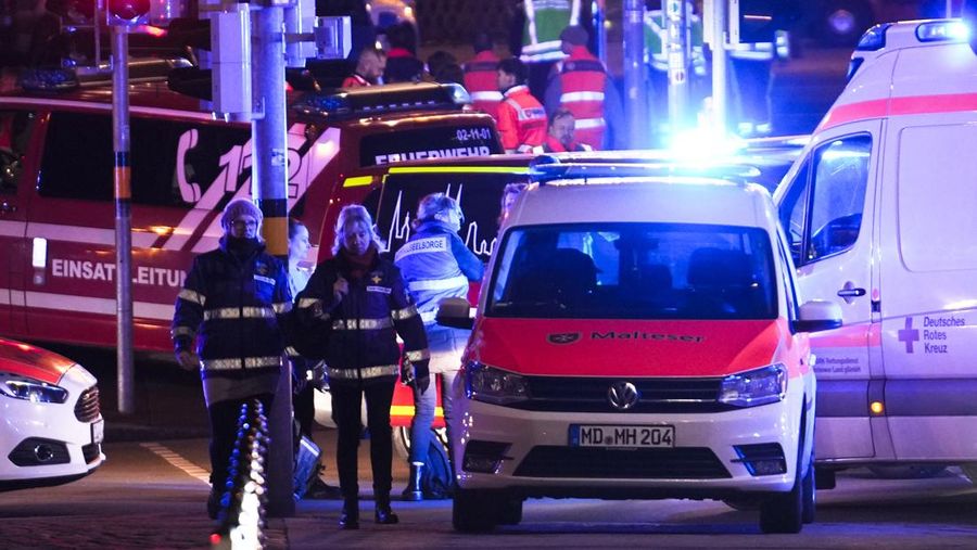 Police stand at a Christmas market in Magdeburg, Germany, early Saturday, Dec. 21, 2024, after a driver plowed into a group of people at the market late Friday. (Hendrik Schmidt/dpa via AP)