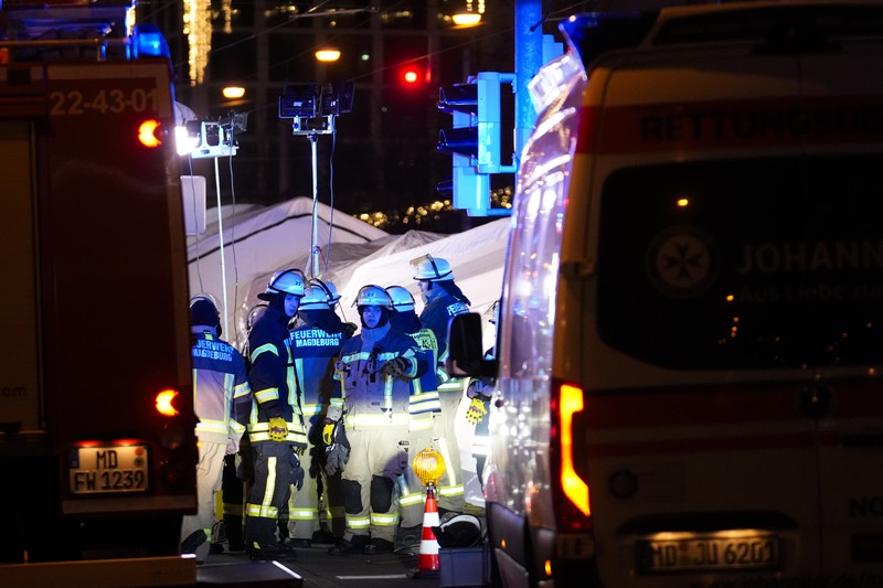 Germany Christmas Market Forensics work on a damaged car sitting with its doors open after a driver plowed into a busy Christmas market in Magdeburg, Germany, early Saturday, Dec. 21, 2024. (Hendrik Schmidt/dpa via AP)