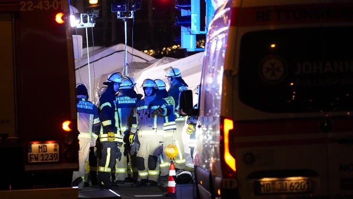 Police stand at a Christmas market in Magdeburg, Germany, early Saturday, Dec. 21, 2024, after a driver plowed into a group of people at the market late Friday. (Hendrik Schmidt/dpa via AP)