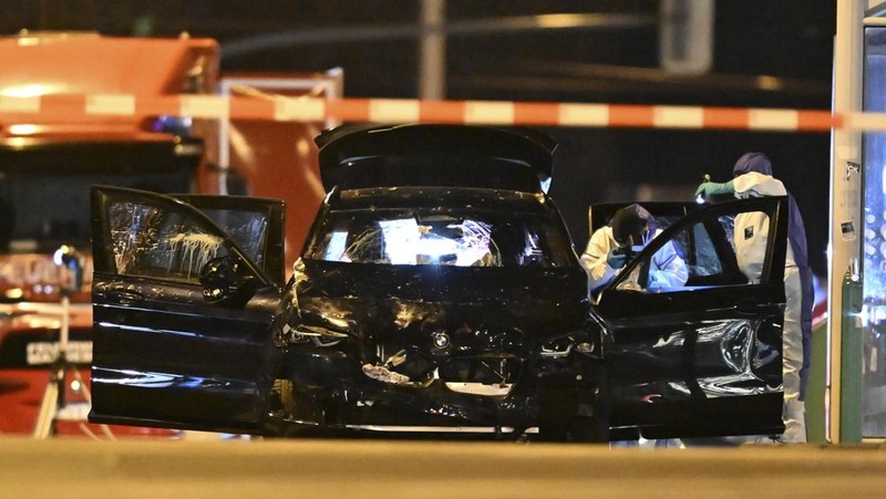 Forensics work on a damaged car sitting with its doors open after a driver plowed into a busy Christmas market in Magdeburg, Germany, early Saturday, Dec. 21, 2024. (Hendrik Schmidt/dpa via AP)