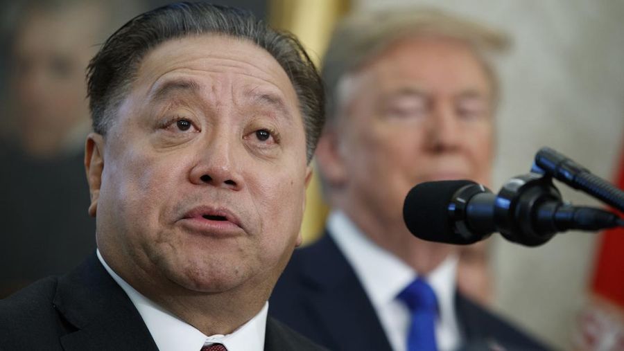 FILE - Broadcom CEO Hock Tan speaks as President Donald Trump listens during an event on Nov. 2, 2017 in Washington. Tan topped the AP survey of CEO pay with a package valued at about $162 million in 2023. (AP Photo/Evan Vucci, File)