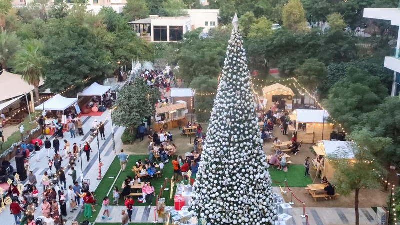 Orang-orang berjalan di sekitar dekorasi Natal di Al Barari Winter Fest, di Dubai, Uni Emirat Arab, 22 Desember 2024. (REUTERS/Abdelhadi Ramahi)