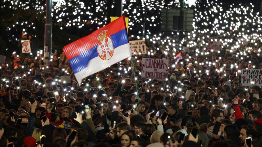 Orang-orang menghadiri protes terhadap kebijakan pemerintah, korupsi, dan kelalaian yang mereka salahkan atas kematian para korban bencana stasiun kereta api Novi Sad pada bulan November, di Beograd, Serbia, 22 Desember 2024. (REUTERS/Djordje Kojadinovic)