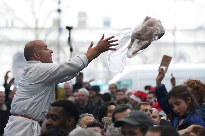 George Gardener, 11, holds a cut of meat at a pre-Christmas meat auction held by G Lawrence butchers at Smithfield Market in London, Britain, December 24, 2024. REUTERS/Hannah McKay
