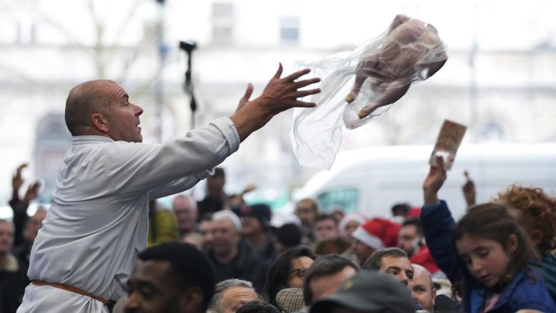 George Gardener, 11, holds a cut of meat at a pre-Christmas meat auction held by G Lawrence butchers at Smithfield Market in London, Britain, December 24, 2024. REUTERS/Hannah McKay