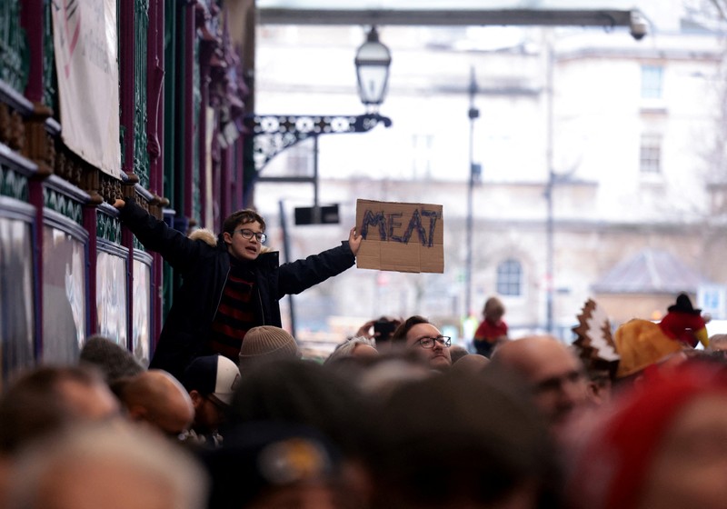 CHRISTMAS-SEASON/BRITAIN-AUCTION George Gardener, 11, holds a cut of meat at a pre-Christmas meat auction held by G Lawrence butchers at Smithfield Market in London, Britain, December 24, 2024. REUTERS/Hannah McKay