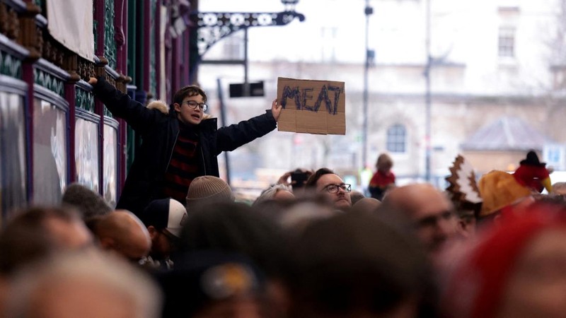 George Gardener, 11, holds a cut of meat at a pre-Christmas meat auction held by G Lawrence butchers at Smithfield Market in London, Britain, December 24, 2024. REUTERS/Hannah McKay