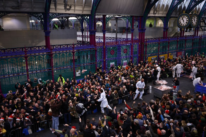 CHRISTMAS-SEASON/BRITAIN-AUCTION George Gardener, 11, holds a cut of meat at a pre-Christmas meat auction held by G Lawrence butchers at Smithfield Market in London, Britain, December 24, 2024. REUTERS/Hannah McKay