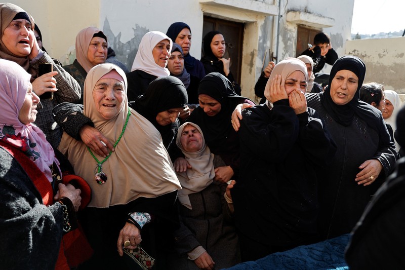 ISRAEL-PALESTINIANS/WEST BANK-STRIKE-FUNERAL A gunman fires a rifle during the funeral of Rayan Bani Odeh, a Palestinian child who was killed in an Israeli airstrike, in Tammoun, near Tubas, in the Israeli-occupied West Bank, December 25, 2024. REUTERS/Raneen Sawafta TPX IMAGES OF THE DAY