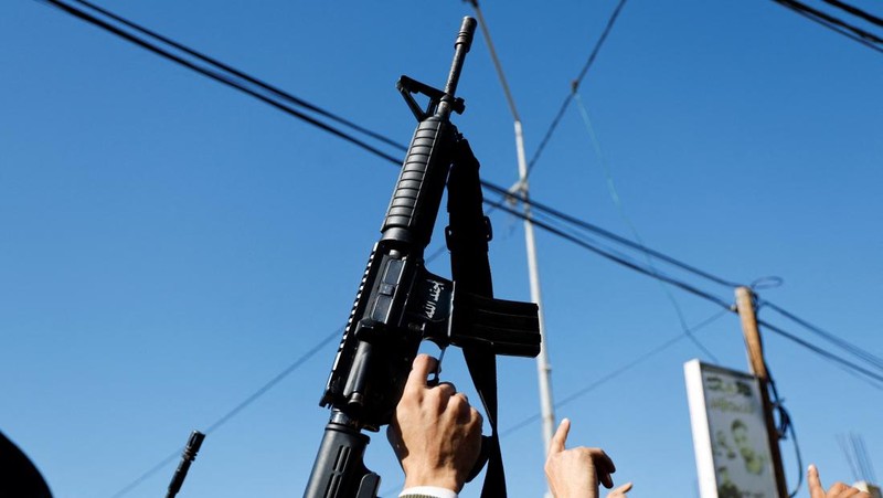 A gunman fires a rifle during the funeral of Rayan Bani Odeh, a Palestinian child who was killed in an Israeli airstrike, in Tammoun, near Tubas, in the Israeli-occupied West Bank, December 25, 2024. REUTERS/Raneen Sawafta     TPX IMAGES OF THE DAY