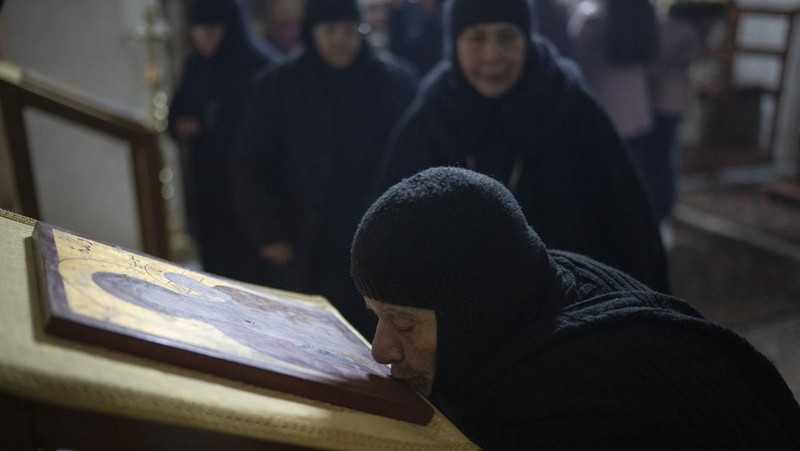 Nuns walk along the Church of the Nativity, traditionally believed to be the birthplace of Jesus, on Christmas Eve, in the West Bank city of Bethlehem, Tuesday, Dec. 24, 2024. (AP Photo/Matias Delacroix)