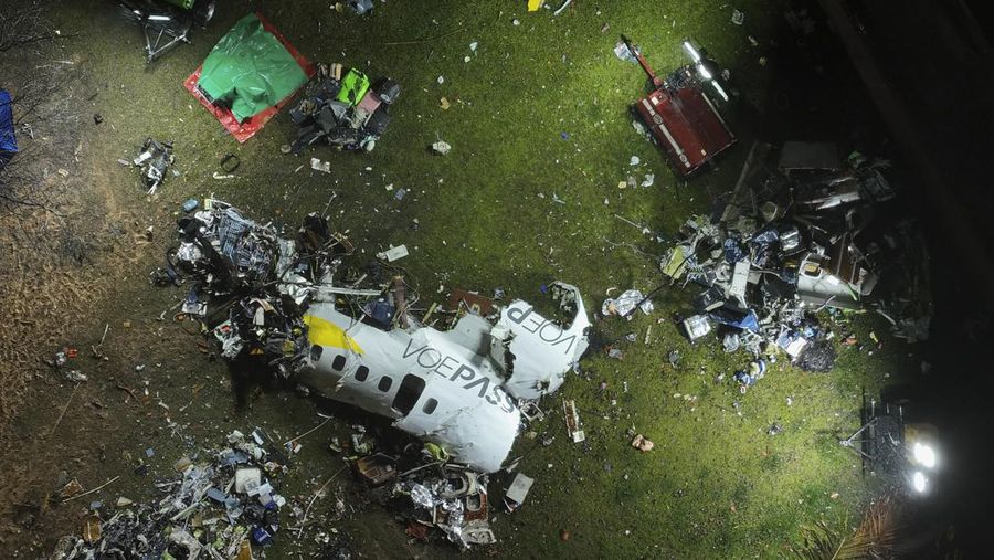 This aerial photo show the burn-out Japan Airlines plane at Haneda airport on Wednesday, Jan. 3, 2024, in Tokyo, Japan. The large passenger plane and a Japanese coast guard aircraft collided on the runway at Tokyo's Haneda Airport on Tuesday and burst into flames, killing several people aboard the coast guard plane, officials said. (Kyodo News via AP)